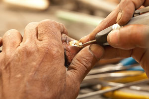 goldsmith making a gold ring